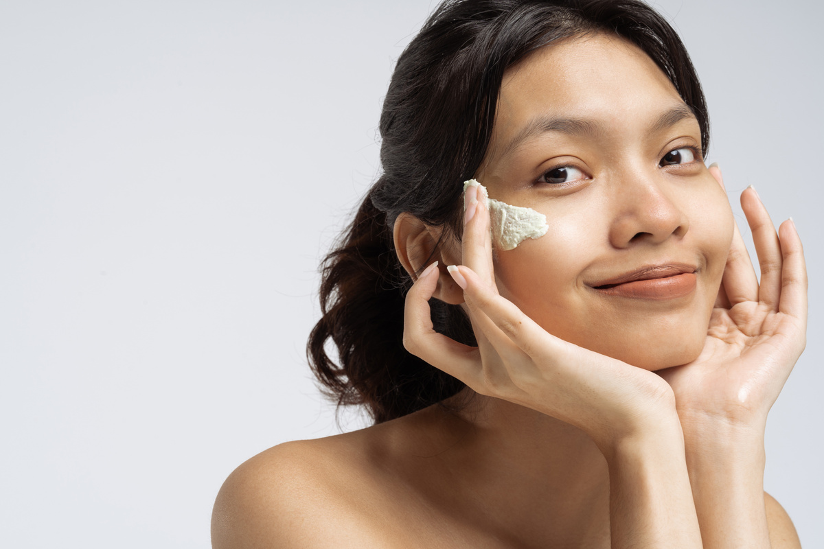 Portrait of a Happy Woman with Cream on Face